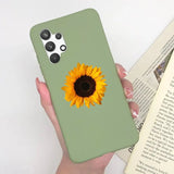 a woman holding a green phone case with a sunflower