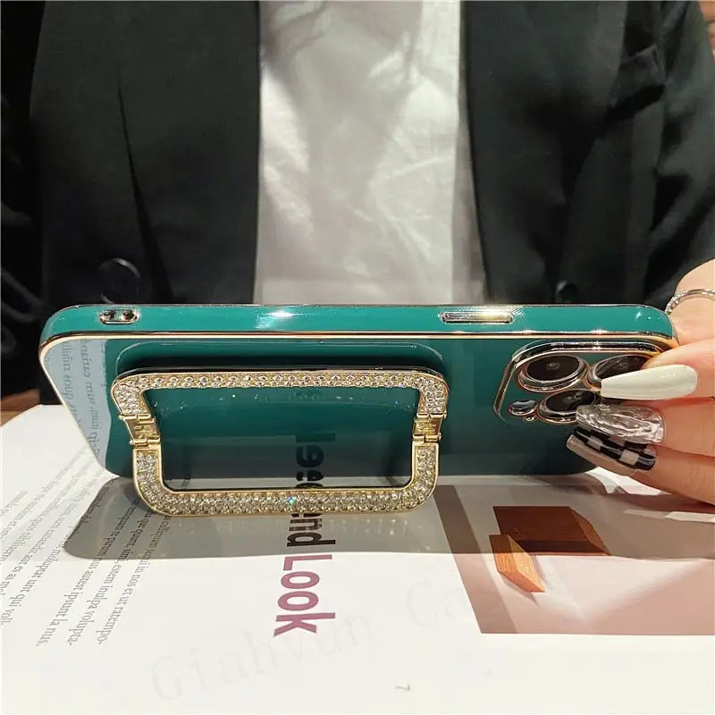 a woman holding a green purse with diamonds