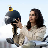 a woman holding a helmet on top of a motorcycle