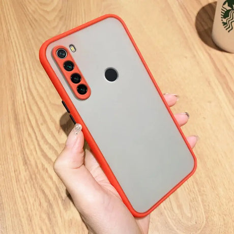 a woman holding a red iphone case