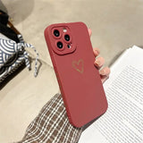 a person holding a red iphone case