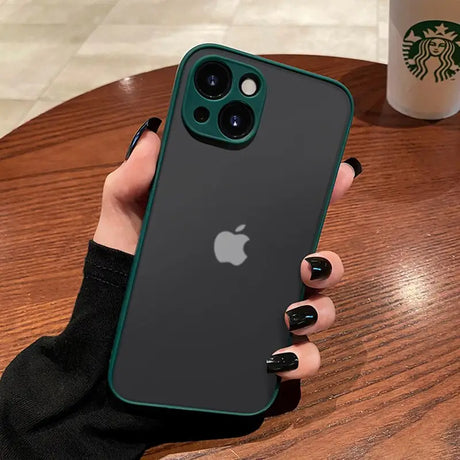 a woman holding an iphone case with a starbucks cup in the background