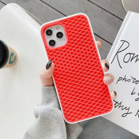 a woman holding a red iphone case