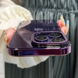 a woman holding a purple iphone in her hand