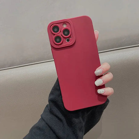 a woman holding a red iphone case