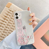 a woman holding a phone case with pink flowers on it