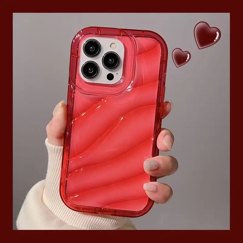 a woman holding a red iphone case