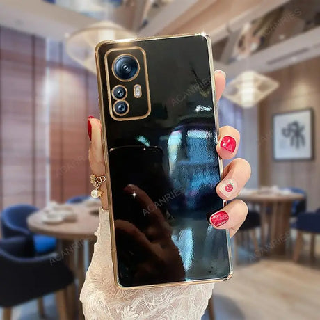 a woman holding up her iphone in a room