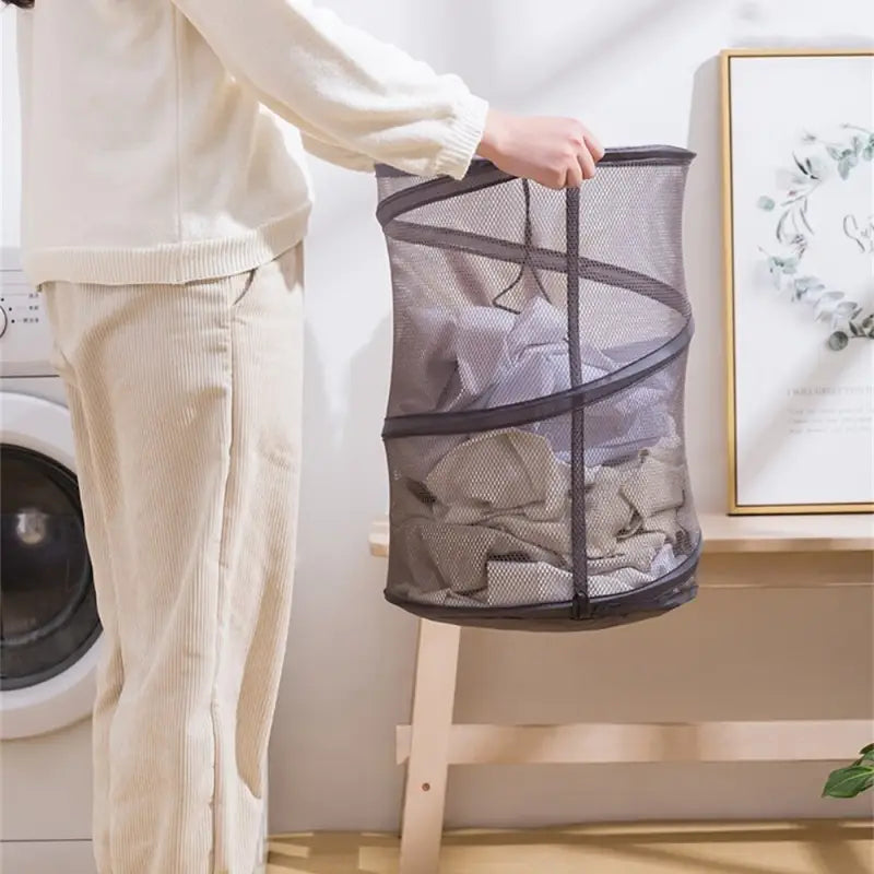 a woman holding a mesh laundry bag