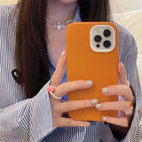 a woman holding a phone in her hand