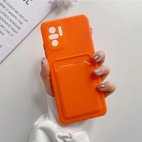 a woman holding an orange phone case