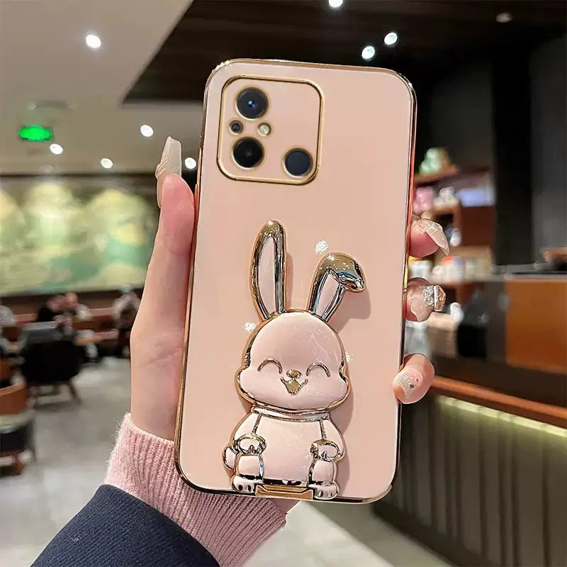 a woman holding a phone case with a rabbit on it