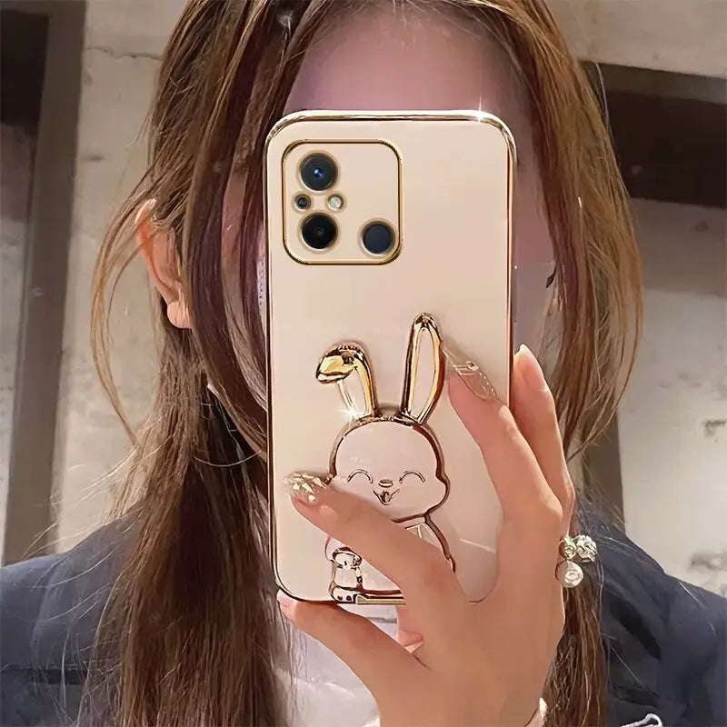 a woman holding up a phone case with a heart