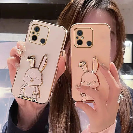 a woman holding up two iphone cases