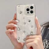 a woman holding a phone case with a bunch of diamonds