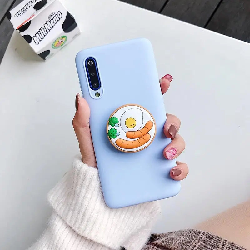 a woman holding a phone case with a cartoon character on it