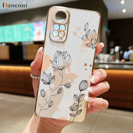 a woman holding a phone case with a flower pattern