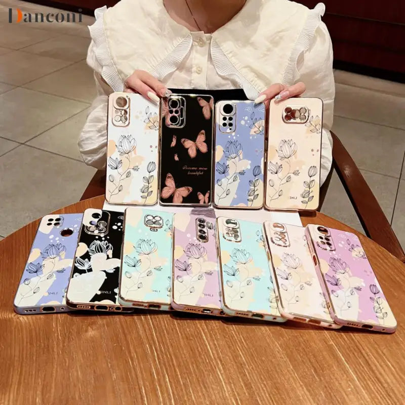 a woman holding a phone case with cartoon characters on it