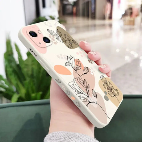 a woman holding a phone case with a flower pattern