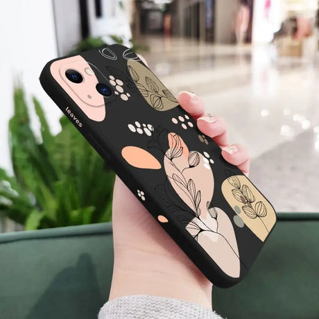 a woman holding a phone case with a flower pattern