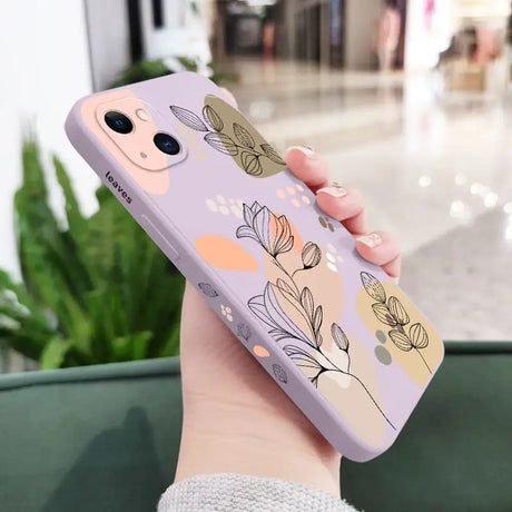 a woman holding a phone case with flowers on it