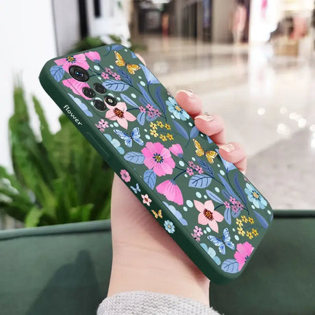 a woman holding a phone case with flowers on it