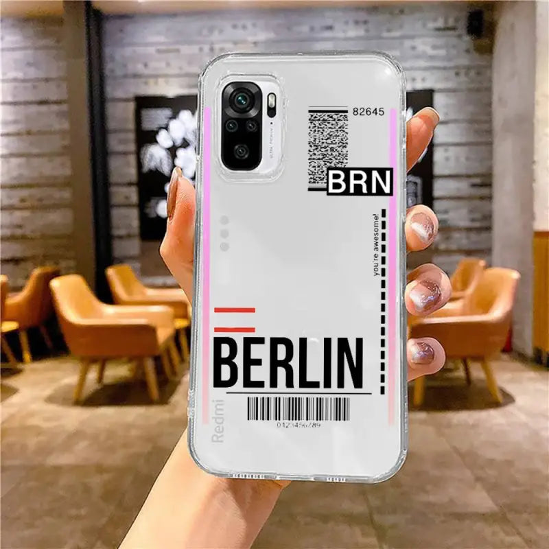 a woman holding up a phone case with a barcode barcode on it