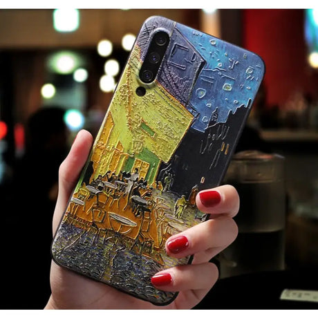 a woman holding a phone case with a painting on it