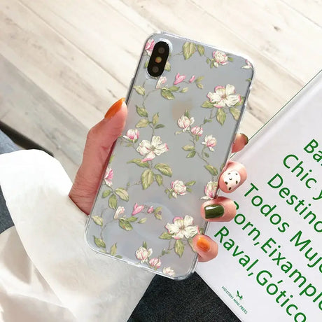 a woman holding a phone case with a floral pattern