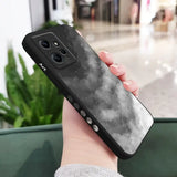 a woman holding a phone case with a black and white image of the moon