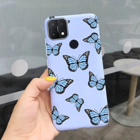 a woman holding a phone case with butterflies on it