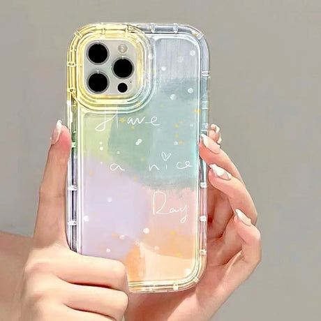 a woman holding a phone case with a watercolor painting on it