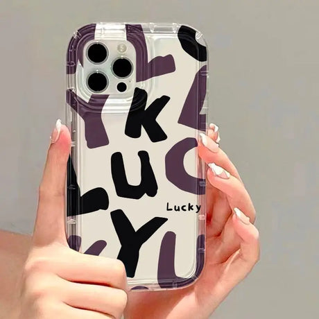 a woman holding a phone case with a purple and black design