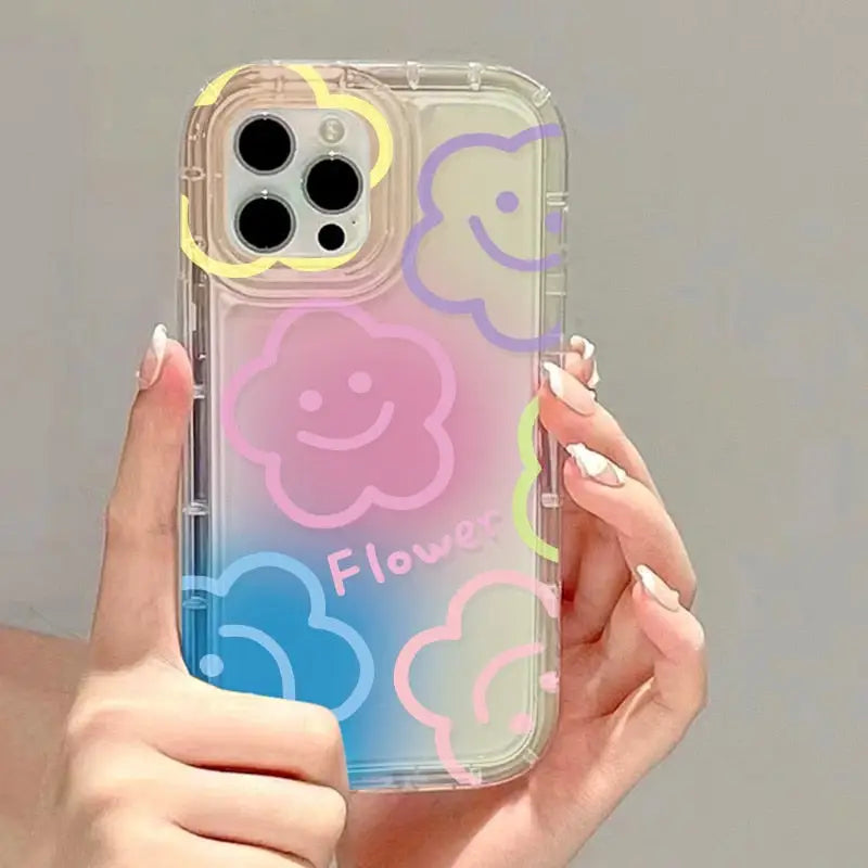 a woman holding a phone case with smiley faces on it
