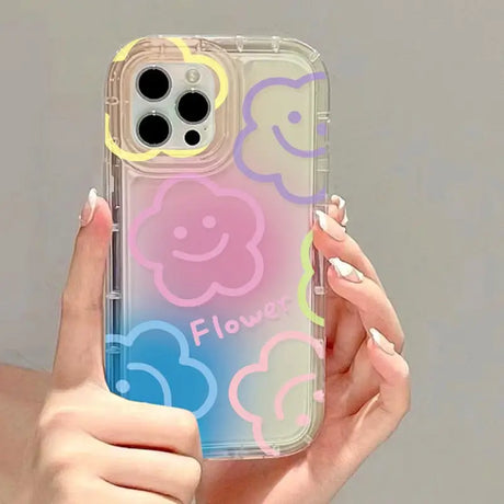 a woman holding a phone case with smiley faces on it