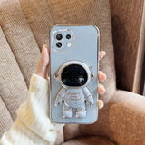 a person holding a phone case with a small astronaut on it