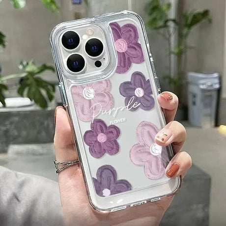 a woman holding a phone case with purple flowers