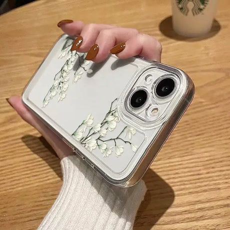 a woman holding a phone case with flowers on it