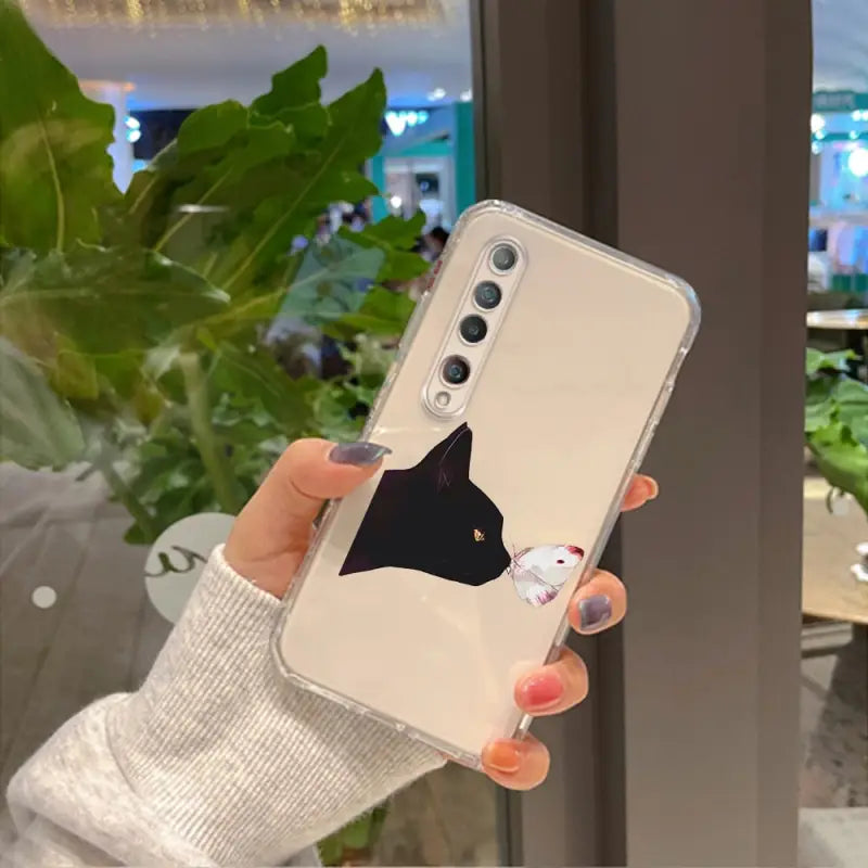 a woman holding up a phone case with a bird on it