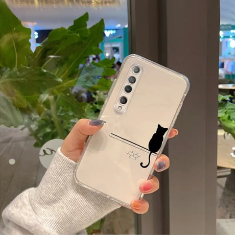 a woman holding a phone case with a cat on it