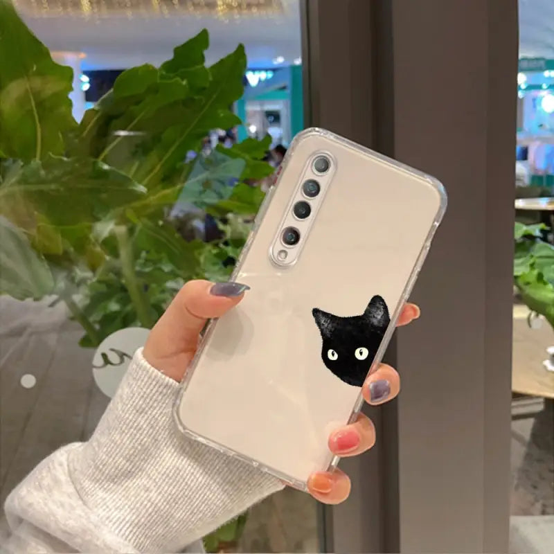 a woman holding a phone case with a cat face
