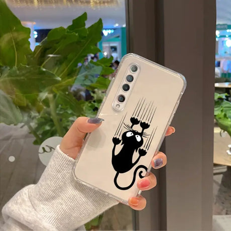 a woman holding a phone case with a black cat on it