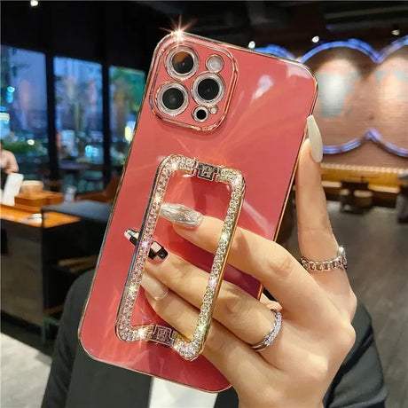 a woman holding a phone case with a ring on it