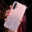 a woman holding a phone case with sparkling stars