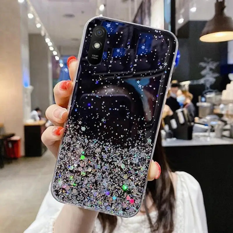 a woman holding up a phone case with a starr design
