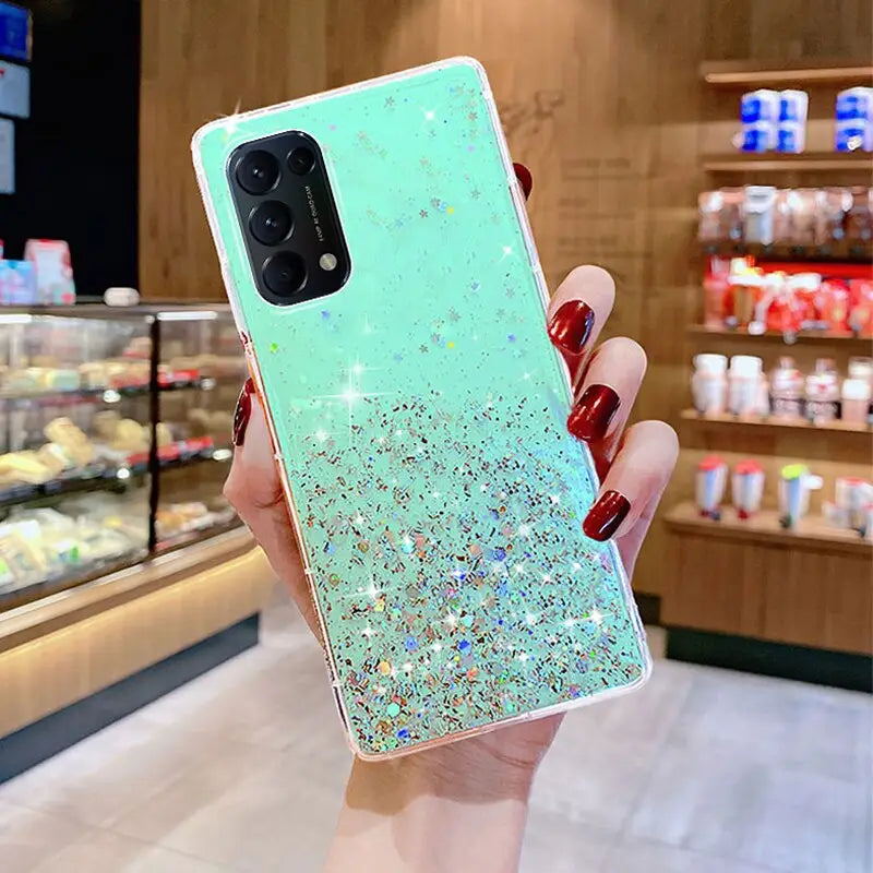 a woman holding up a phone case with glitter