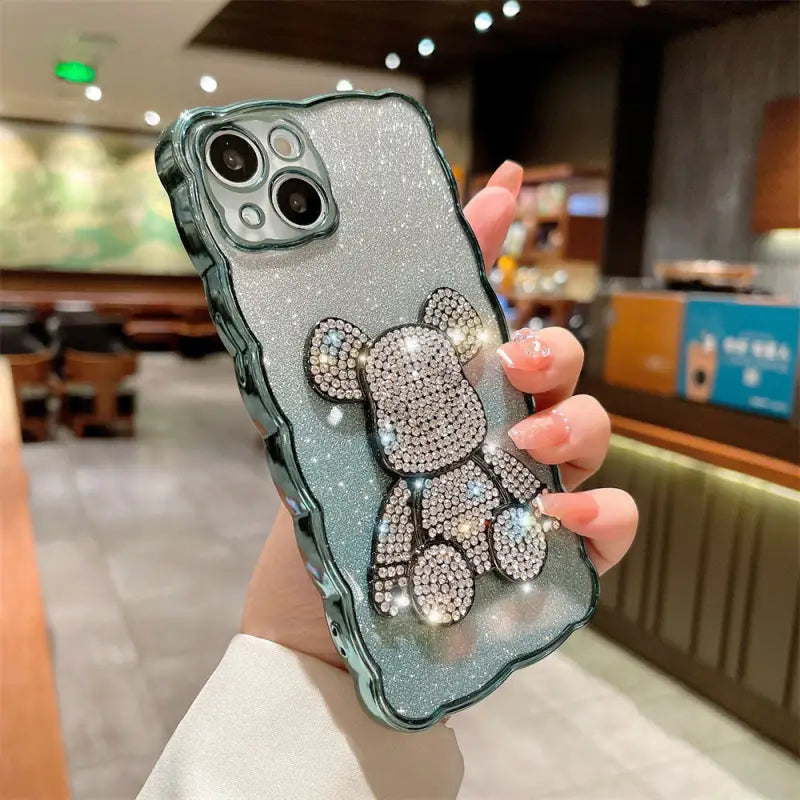 a woman holding a phone case with a teddy bear on it