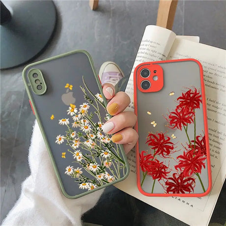 a woman holding a phone case with flowers on it