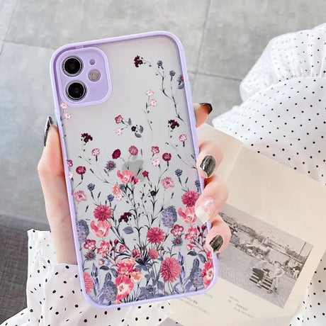 a woman holding a phone case with flowers on it