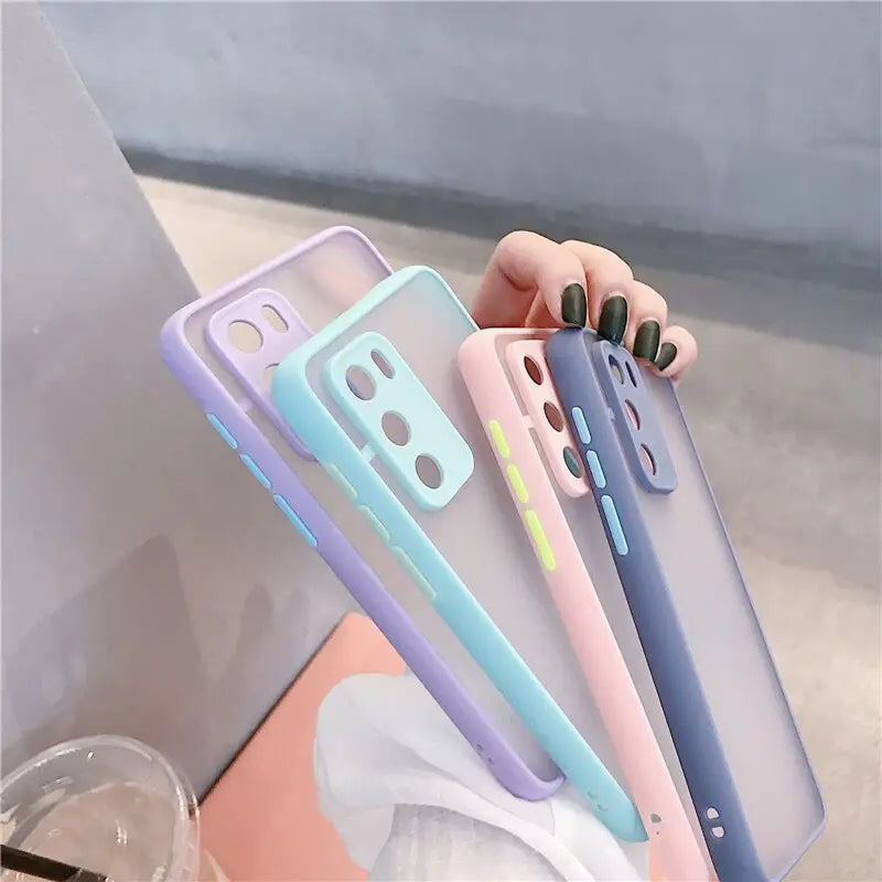 a woman holding a phone case with a phone in the background